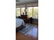 Bright bedroom with a large window overlooking the scenic greenery, hardwood flooring, and neutral decor at 330 Concord St # Th17, Charleston, SC 29401