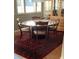 Charming dining room with a round wood table and elegant rug at 330 Concord St # Th17, Charleston, SC 29401