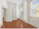 Bright bedroom with hardwood floors, white trim, and ample natural light at 35 Society St # D, Charleston, SC 29401