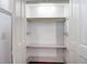 Bright, tidy closet featuring a wooden dowel and a shelf with white painted doors and trim at 35 Society St # D, Charleston, SC 29401
