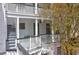 View of a traditional courtyard with white siding and a lush tree at 35 Society St # D, Charleston, SC 29401