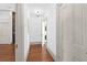 Hallway features wooden floors, neutral walls, and access to rooms with white doors at 35 Society St # D, Charleston, SC 29401