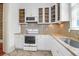 Bright kitchen features white cabinets, modern appliances, and stylish backsplash with neutral counters at 35 Society St # D, Charleston, SC 29401