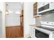 View from doorway of kitchen with stainless steel appliances and open to a living area at 35 Society St # D, Charleston, SC 29401