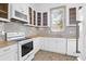 Well-lit kitchen with white cabinets, stainless steel appliances, neutral countertops, and patterned tile floors at 35 Society St # D, Charleston, SC 29401