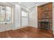 Elegant living room features a brick fireplace, hardwood floors, and detailed trim at 35 Society St # D, Charleston, SC 29401