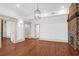 Bright living room featuring hardwood floors, white walls, an exposed brick fireplace and doorways at 35 Society St # D, Charleston, SC 29401