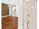 Open doorway leading to a living area with exposed brick wall and a view of the kitchen at 35 Society St # D, Charleston, SC 29401