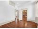 Open-concept living area with hardwood floors and views of the exposed brick fireplace at 35 Society St # D, Charleston, SC 29401