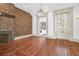 Spacious living room boasts hardwood floors, exposed brick wall, a fireplace and a chandelier at 35 Society St # D, Charleston, SC 29401