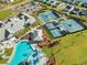 Aerial view of a community center featuring a pool, tennis courts, and clubhouse, promising an active lifestyle at 403 Hidden Meadow Ln, Summerville, SC 29486