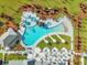 Aerial view showcasing the community pool, featuring resort-style lounging, a hot tub, and lush landscaping at 403 Hidden Meadow Ln, Summerville, SC 29486