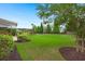 Spacious backyard with manicured lawn, mature trees, and wrought iron fence along a green space at 403 Hidden Meadow Ln, Summerville, SC 29486