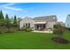 Beautiful backyard with lush green lawn, mature trees, patio area, and manicured landscaping at 403 Hidden Meadow Ln, Summerville, SC 29486