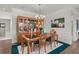 Dining room with a dark-top wooden table and upholstered chairs, illuminated by a modern chandelier at 403 Hidden Meadow Ln, Summerville, SC 29486