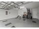 Spacious garage featuring a clear garage door, coated floors, and ample space for storage and projects at 403 Hidden Meadow Ln, Summerville, SC 29486