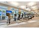 Well-equipped gym with modern cardio machines, large windows, and multiple TV screens for entertainment at 403 Hidden Meadow Ln, Summerville, SC 29486