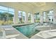 Indoor hot tub area with large windows offering views of palm trees and neighborhood at 403 Hidden Meadow Ln, Summerville, SC 29486