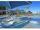 Stunning pool with lounge chairs in the water and shade canopies, perfect for relaxation and recreation at 403 Hidden Meadow Ln, Summerville, SC 29486