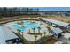 Aerial view showcases a modern community pool and clubhouse amidst a scenic neighborhood landscape at 403 Ripple Park Dr, Summerville, SC 29486
