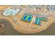 Aerial view showcases community pool, tennis courts, and basketball court near neighborhood homes and calm lake at 403 Ripple Park Dr, Summerville, SC 29486