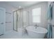 Modern bathroom with a standalone tub, glass-enclosed shower, and white subway tile at 403 Ripple Park Dr, Summerville, SC 29486