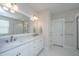 Modern bathroom featuring double vanity, large mirror, glass-enclosed shower, and tiled floors at 403 Ripple Park Dr, Summerville, SC 29486