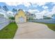 Yellow detached garage with covered area and a well-maintained lawn at 403 Ripple Park Dr, Summerville, SC 29486