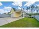 Yellow detached garage with covered area and a well-maintained lawn at 403 Ripple Park Dr, Summerville, SC 29486