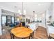 Open-concept kitchen and living room with hardwood floors, blue couch, and white kitchen cabinets at 403 Ripple Park Dr, Summerville, SC 29486