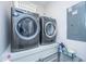 Modern laundry room with gray front-load washer and dryer, plus storage at 403 Ripple Park Dr, Summerville, SC 29486
