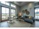Bright sitting area includes a comfortable couch, chairs, decorative wall art, and access to the outdoors at 403 Ripple Park Dr, Summerville, SC 29486