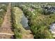 An aerial shot showcases a home nestled near a golf course, pond, and lush trees at 4872 Law Blvd, Summerville, SC 29485