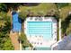 An aerial view of a community pool, tennis court, and meticulously landscaped surroundings at 4872 Law Blvd, Summerville, SC 29485