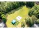 This aerial view shows the community playground and sports field surrounded by lush green space and trees at 4872 Law Blvd, Summerville, SC 29485