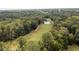 Aerial view capturing the lush green golf course, a tranquil lake, and towering trees surrounding the area at 4872 Law Blvd, Summerville, SC 29485