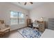 Bright bedroom with wood floors, a ceiling fan, a large window with blinds, and desk with office chair at 4872 Law Blvd, Summerville, SC 29485