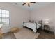 Bedroom featuring wood floors, a metal bedframe with white linens, and neutral walls with a window at 4872 Law Blvd, Summerville, SC 29485