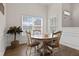 Bright dining area with wooden table, comfortable chairs, a plant, and natural light at 4872 Law Blvd, Summerville, SC 29485