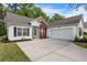 Inviting one-story home featuring an attached garage, brick accents, and a concrete driveway at 4872 Law Blvd, Summerville, SC 29485