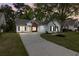 Charming single-story home with a well-manicured lawn, long driveway, and attached garage at 4872 Law Blvd, Summerville, SC 29485