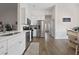 Bright, white kitchen with stainless appliances, hard surface counters and light-filled dining area at 4872 Law Blvd, Summerville, SC 29485