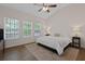 The main bedroom has ample natural light, neutral paint and hardwood flooring at 4872 Law Blvd, Summerville, SC 29485