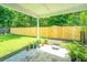 Back patio featuring a concrete slab, new wood fence, and greenery surrounding the area at 505 Laurel Ridge Rd, North Charleston, SC 29418