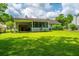 Lovely backyard featuring a lush lawn, mature trees, and a screened-in porch, perfect for outdoor relaxation and entertaining at 505 Laurel Ridge Rd, North Charleston, SC 29418