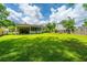 Expansive backyard featuring a well-maintained lawn, mature trees, and a screened-in porch for outdoor enjoyment at 505 Laurel Ridge Rd, North Charleston, SC 29418