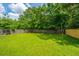 Spacious backyard with lush green grass, mature trees, and a newly constructed wooden fence for added privacy at 505 Laurel Ridge Rd, North Charleston, SC 29418