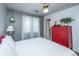 Bedroom with hardwood floors, a white bed, white curtains, and a vibrant red cabinet at 505 Laurel Ridge Rd, North Charleston, SC 29418