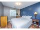 Bedroom featuring hardwood floors, a plush bed, warm lamps, and bright window in a naturally lit space at 505 Laurel Ridge Rd, North Charleston, SC 29418