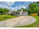 View of a well maintained single-story home featuring a long driveway leading to a garage at 505 Laurel Ridge Rd, North Charleston, SC 29418